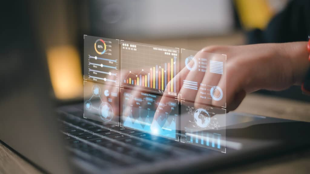 Business professional analyzing CRM dashboard analytics on a laptop