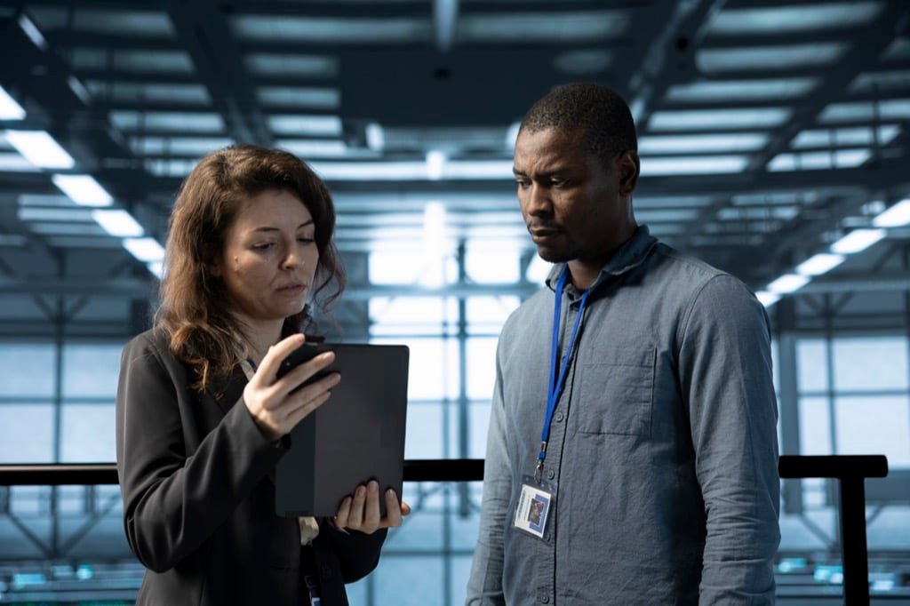 Team of programmers in a data center using automation tools on a tablet