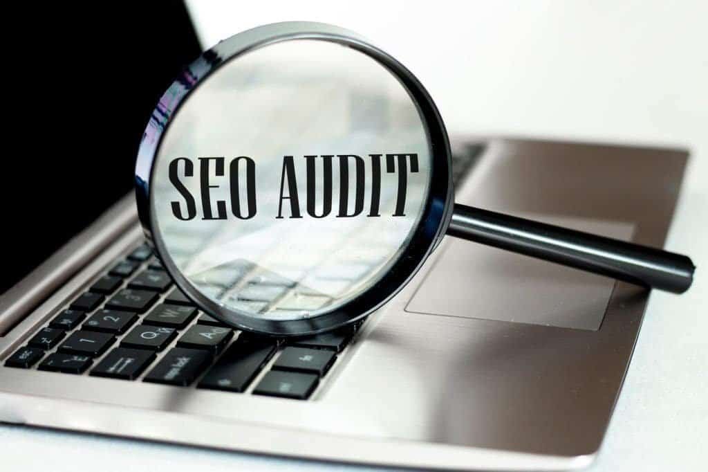 SEO Audit - Laptop computer with magnifying glass