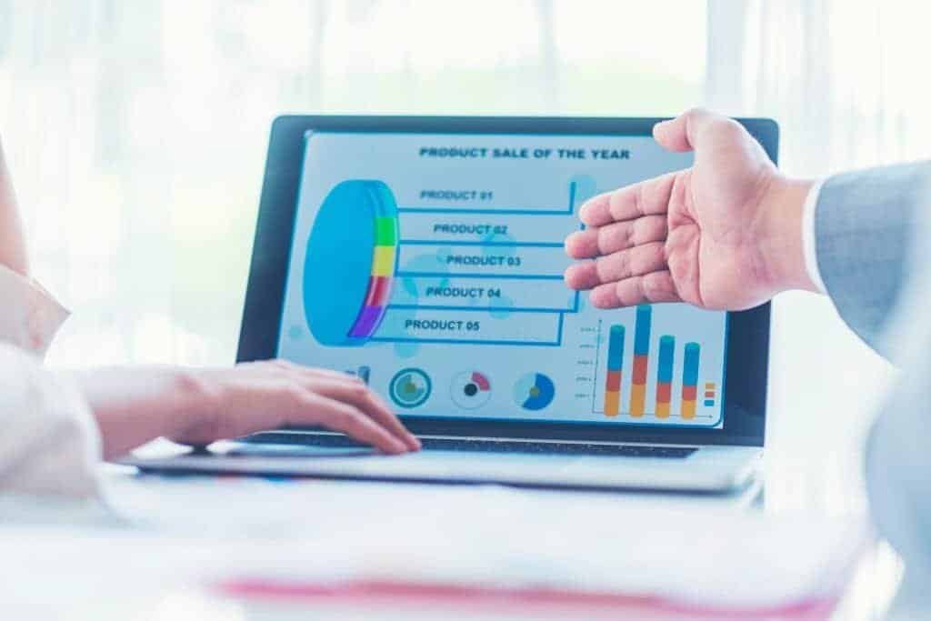Social media metrics presentation on a laptop screen showing a pie chart and bar graphs, with a focus on campaign optimization and key performance indicators (KPIs) in marketing strategy.