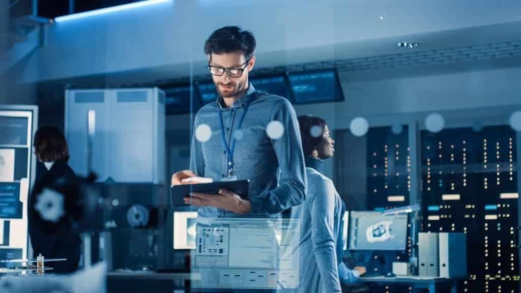 In Technology Research Facility: Chief Engineer with Tablet Computer