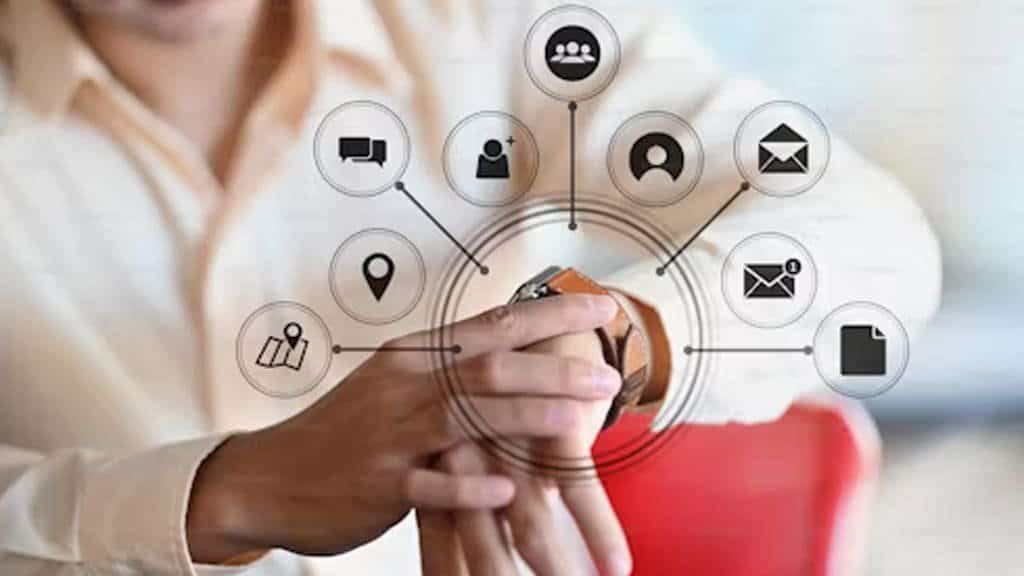 Close-up of a person checking a smartwatch, surrounded by icons representing communication, emails, and location services.